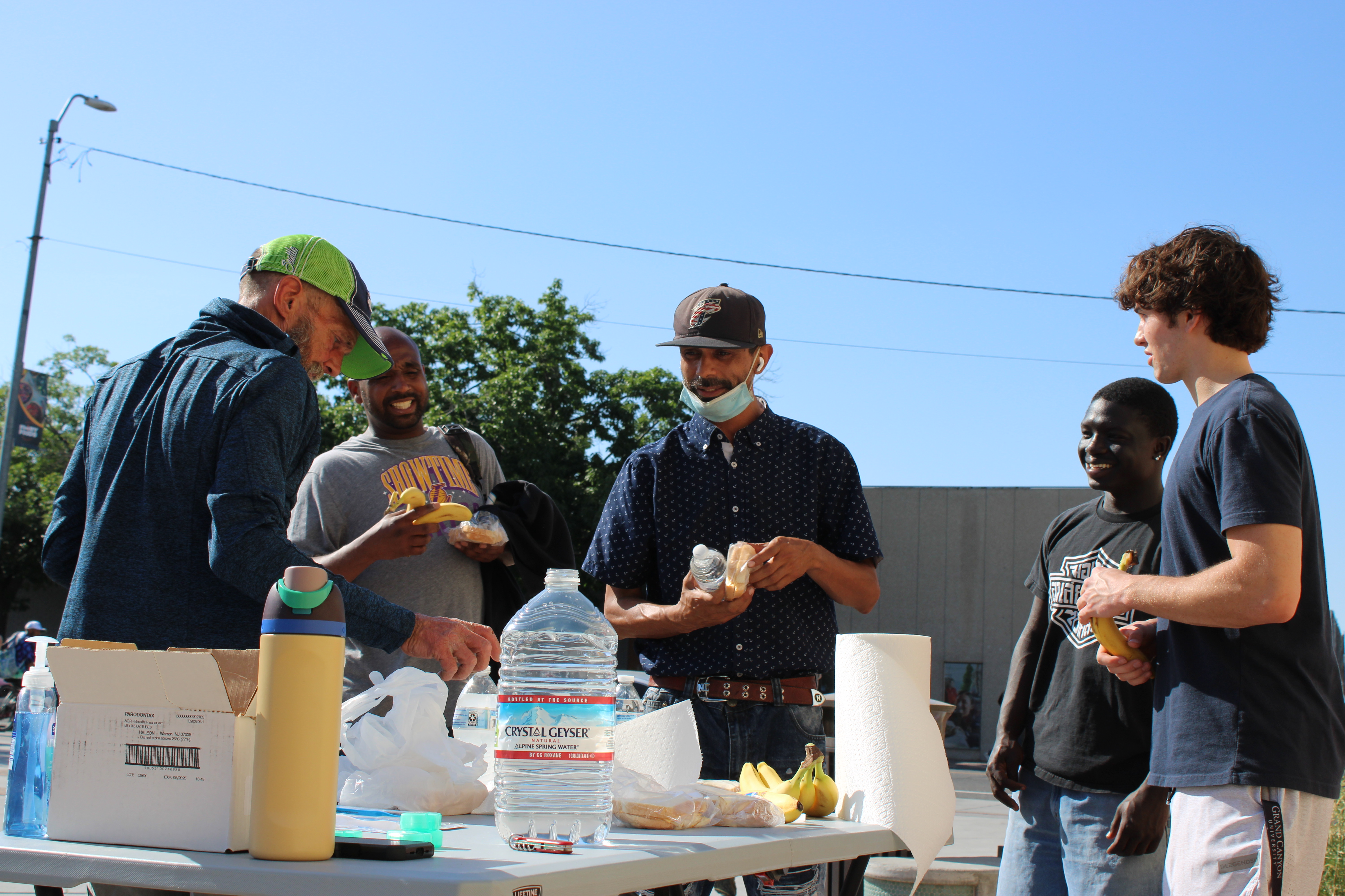Volunteers and community members gathered together at an outreach table